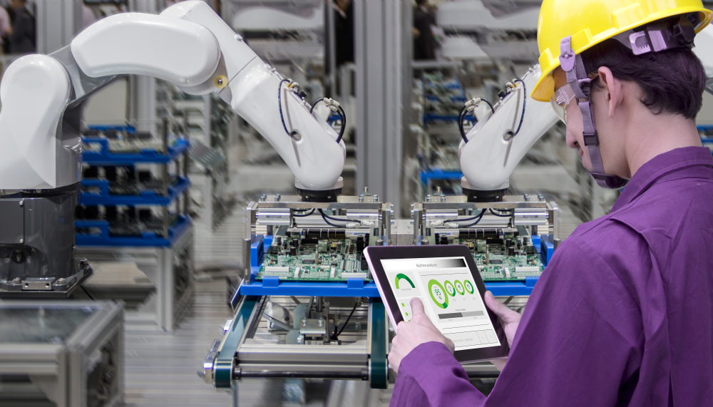 Industry 4.0 Worker with Tablet Computer in front of Robot