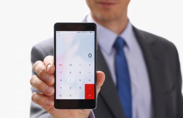 Businessman with Smartphone Calculator