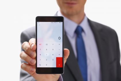 Businessman with Smartphone Calculator