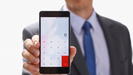 Businessman with Smartphone Calculator